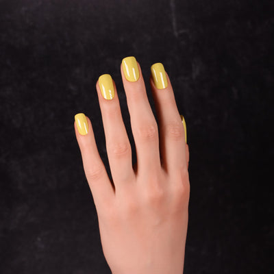 Viscacha by Dimension Nails, mustard yellow creme with a chartreuse-olive lean in shadow areas, on a light skin tone hand