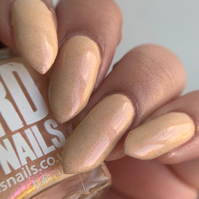 Warm Fleece by 'Ard As Nails, warm peachy-nude cream with golden pink iridescent shimmer, on a light-medium skin tone hand
