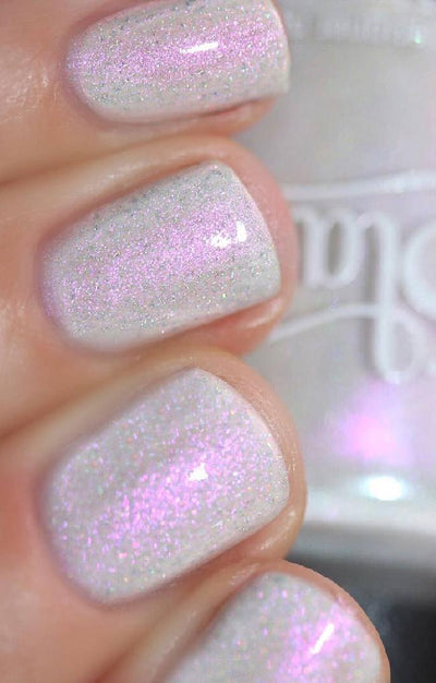 Bean Toes by Starrily, light grey creme showing intense pink-purple shimmer flash with silver holo micro flecks under direct flash, on a light skin tone hand