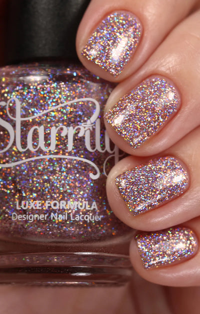 Dollhouse by Starrily, dusty rose holographic micro-glitter with full-spectrum rainbow sparkle under direct flash, bottle held in a light hand