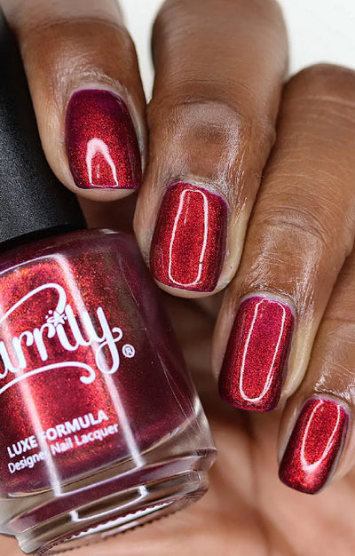 Dragon by Starrily, purple-base shimmer shifting to vivid copper-red in direct bright daylight, on a deep skin tone hand