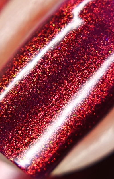 Dragon by Starrily, macro close-up of dense copper-to-orange shimmer particles over deep crimson-magenta base under direct flash