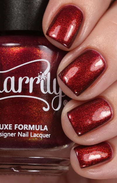 Dragon by Starrily, purple shimmer reading vivid crimson-red with fiery copper-orange flash in studio light, on a light skin tone hand