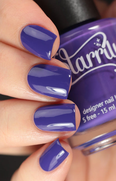 Gravity by Starrily, medium blue-toned purple creme with glossy finish, on a light skin tone hand
