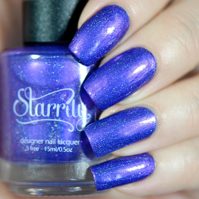 Violet Twilight by Starrily, blue-violet holographic shimmer with multitonal periwinkle-purple shimmer shift and scattered holo flecks, on a light skin tone hand