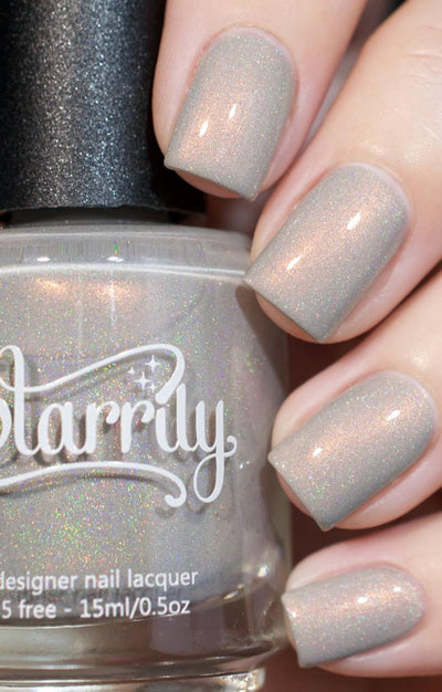 Moon Glow by Starrily, grey holographic shimmer creme with copper shimmer and micro holographic flecks, bottle held in a light hand