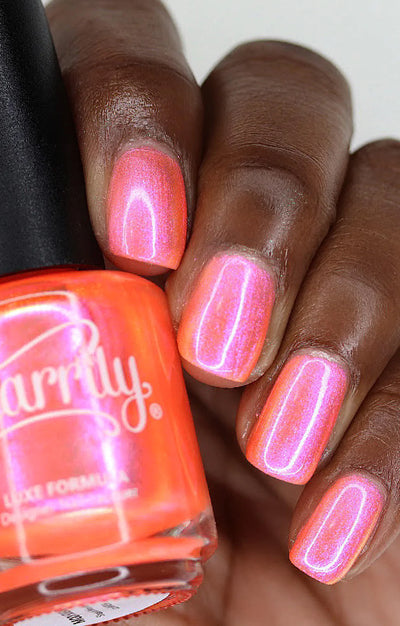 Moon Sugar by Starrily, neon coral-orange multichrome shimmer with vivid pink iridescent color shift, on a rich skin tone hand