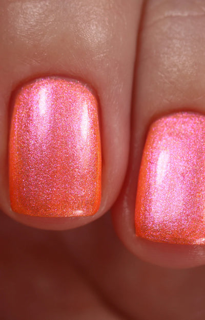 Moon Sugar by Starrily, neon coral-orange shimmer with pink color shift and gold micro-particle flash in natural daylight, on a light-medium skin tone hand