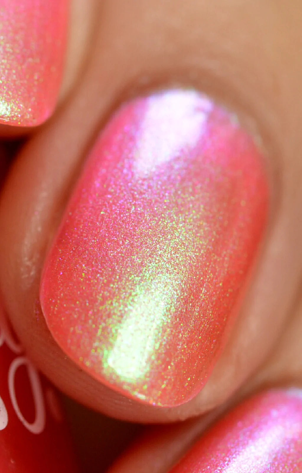 Nectar by Starrily, macro close-up of coral-pink multichrome shimmer flaring yellow-green to magenta in bright directional daylight