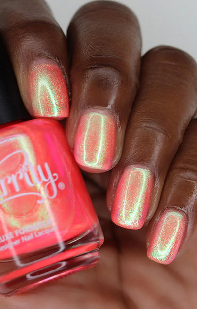 Nectar by Starrily, coral-pink multichrome shimmer with vivid yellow-green color shift, bottle held in a rich hand