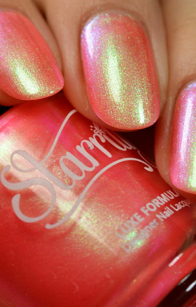 Nectar by Starrily, coral-pink multichrome shimmer with vivid yellow-green to hot pink shift in bright daylight, on a light skin tone hand