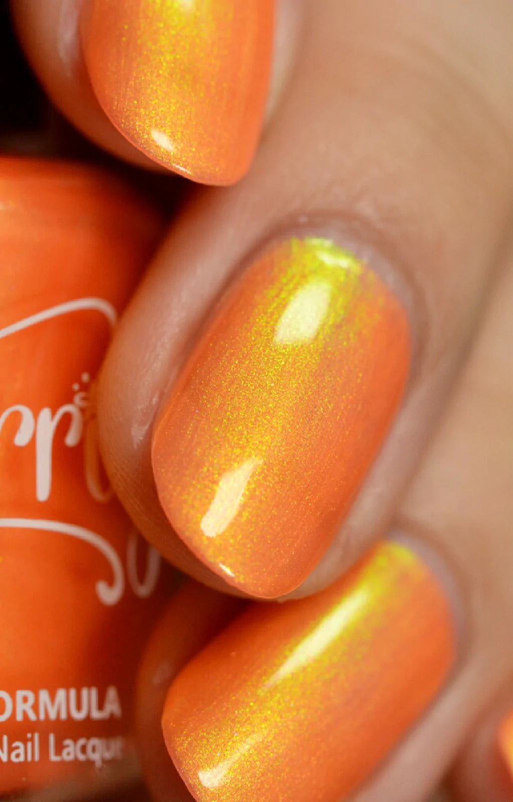 Peach Glow by Starrily, vivid orange base with chartreuse-to-gold duochrome shimmer flashing in direct daylight, on a light skin tone hand