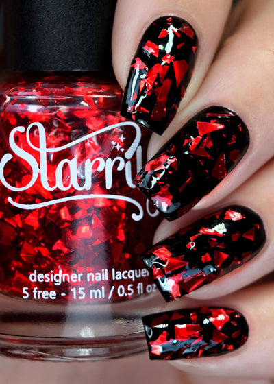 Rose Petals by Starrily, ruby red metallic foil-shard glitter topper over a jet black creme base, layering demo on a light skin tone hand
