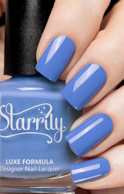 Cloudscape by Starrily, medium periwinkle blue opaque creme, bottle held in a light hand