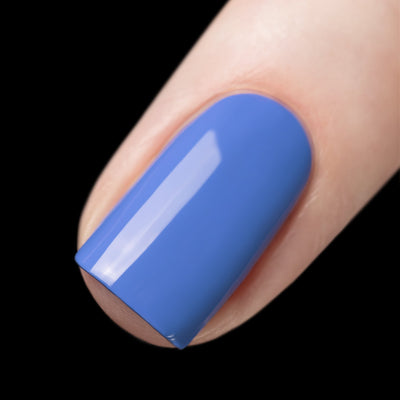 Cloudscape by Starrily, medium periwinkle blue creme with mirror-like shine, on a light skin tone hand