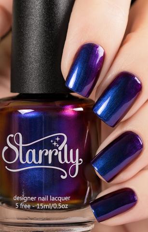 Dark Music (Multichrome) by Starrily, blue-purple multichrome mid-shift from blue to purple to magenta-red, bottle held in a light hand