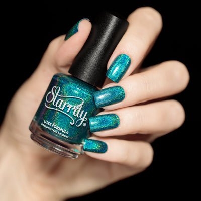 Tidal Wave by Starrily, rich teal-green linear holographic showing golden holographic scatter, bottle held in a light skin tone hand