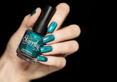 Tidal Wave by Starrily, vivid teal linear holographic with foil-like reflectivity and intense rainbow spectral scatter, bottle held in a light skin tone hand