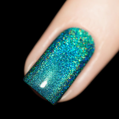 Tidal Wave by Starrily, teal-to-blue linear holographic with full rainbow spectral scatter under direct flash, on a light skin tone hand