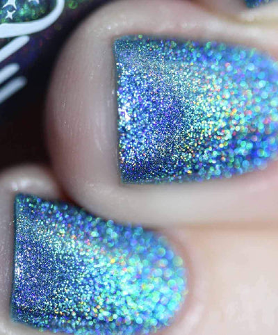 Cat Eyes by Starrily, macro close-up of full blue-to-teal-to-violet holographic dispersion across three nails under direct flash
