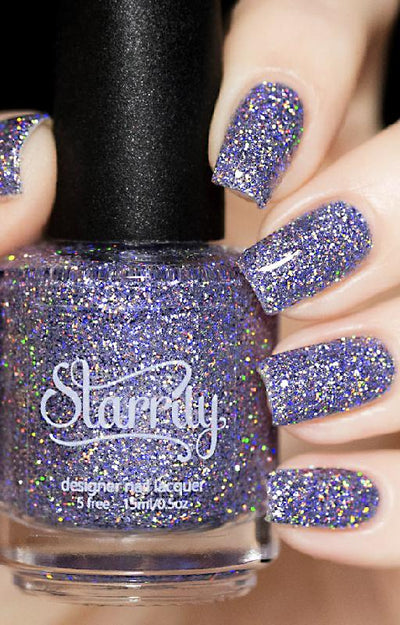 Damsel by Starrily, lilac holographic glitter in clear base with rainbow spectral scatter, bottle held in a light hand