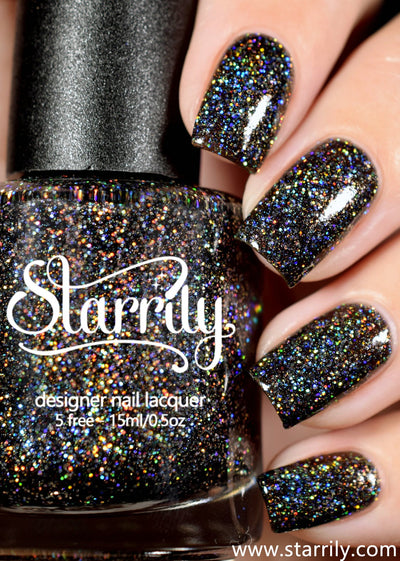 E=mc^2 by Starrily, dark grey jelly with high-density gold and blue holographic glitter sparkle in studio light, bottle held in a light skin tone hand