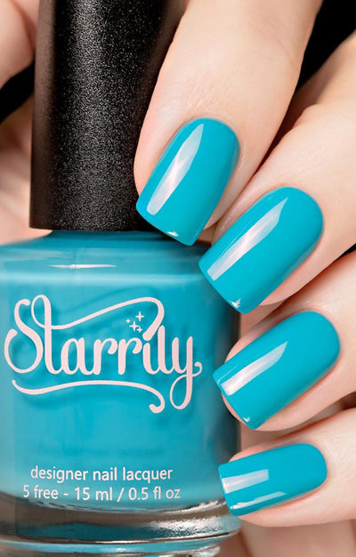 Private Island by Starrily, vivid cyan-teal blue holographic glitter creme, high-gloss opaque finish, bottle held in a light hand