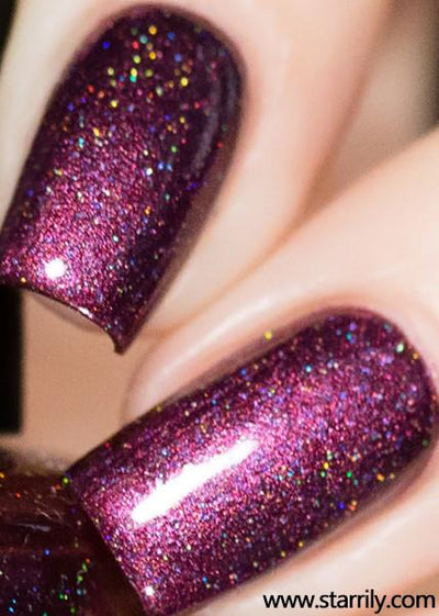 True Blood by Starrily, deep berry-maroon holographic with dense linear rainbow scatter and strong magenta-pink shift under direct flash, on a light skin tone hand