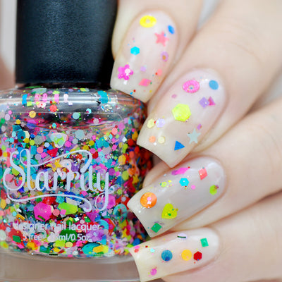 Toy Story by Starrily, chunky confetti glitter topper over sheer milky white base with neon pink, yellow, and rainbow star and heart shapes, on a light skin tone hand