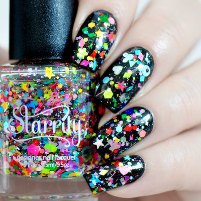 Toy Story by Starrily, chunky multicolor glitter topper over black base with holographic micro glitter and rainbow shaped confetti including stars, hearts, and flowers, on a light skin tone hand