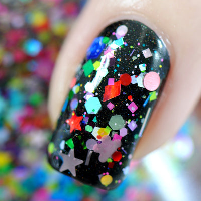 Toy Story by Starrily, glitter topper, macro close-up of multi-shape glitters on nail over black base showing stars, hexagons, squares, and circles in red, neon green, teal, and pink