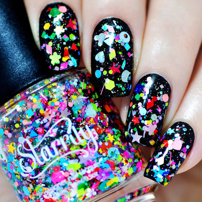 Toy Story by Starrily, chunky iridescent glitter topper over black base with neon pink, teal, and rainbow shaped particles including stars, flowers, and hearts, on a light skin tone hand
